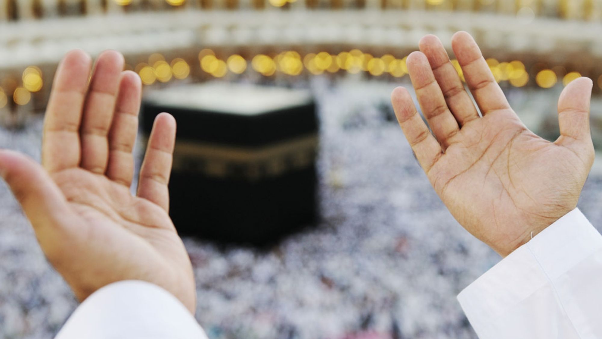 Muslim pilgrim praying in front of the Kaaba during spiritual Umrah journey