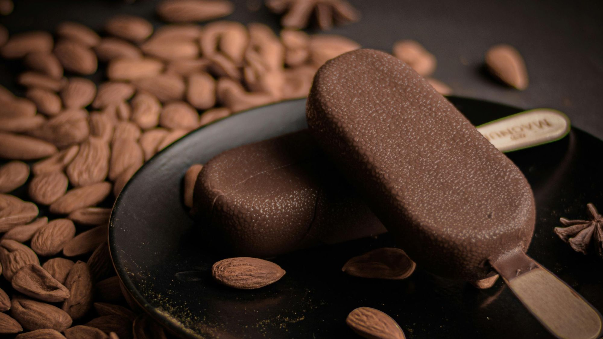 Oreo and coffee ice cream flavors in a plate alongwith almonds