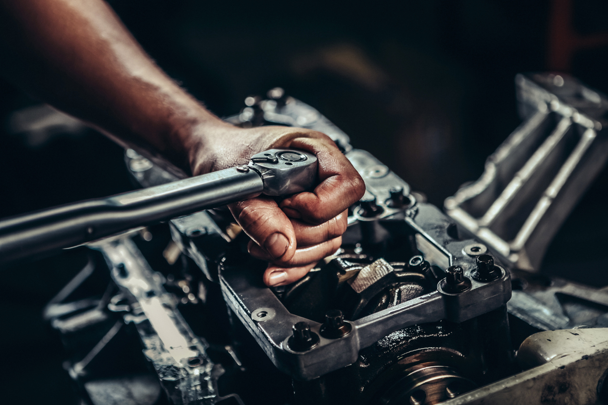 Mechanic working on diesel engine for better performance