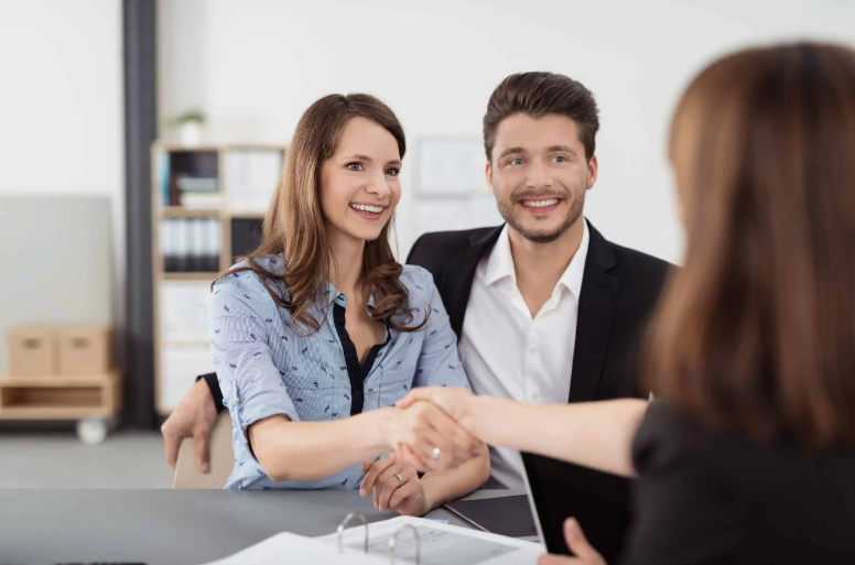 Couple discussing about property with real estate agents