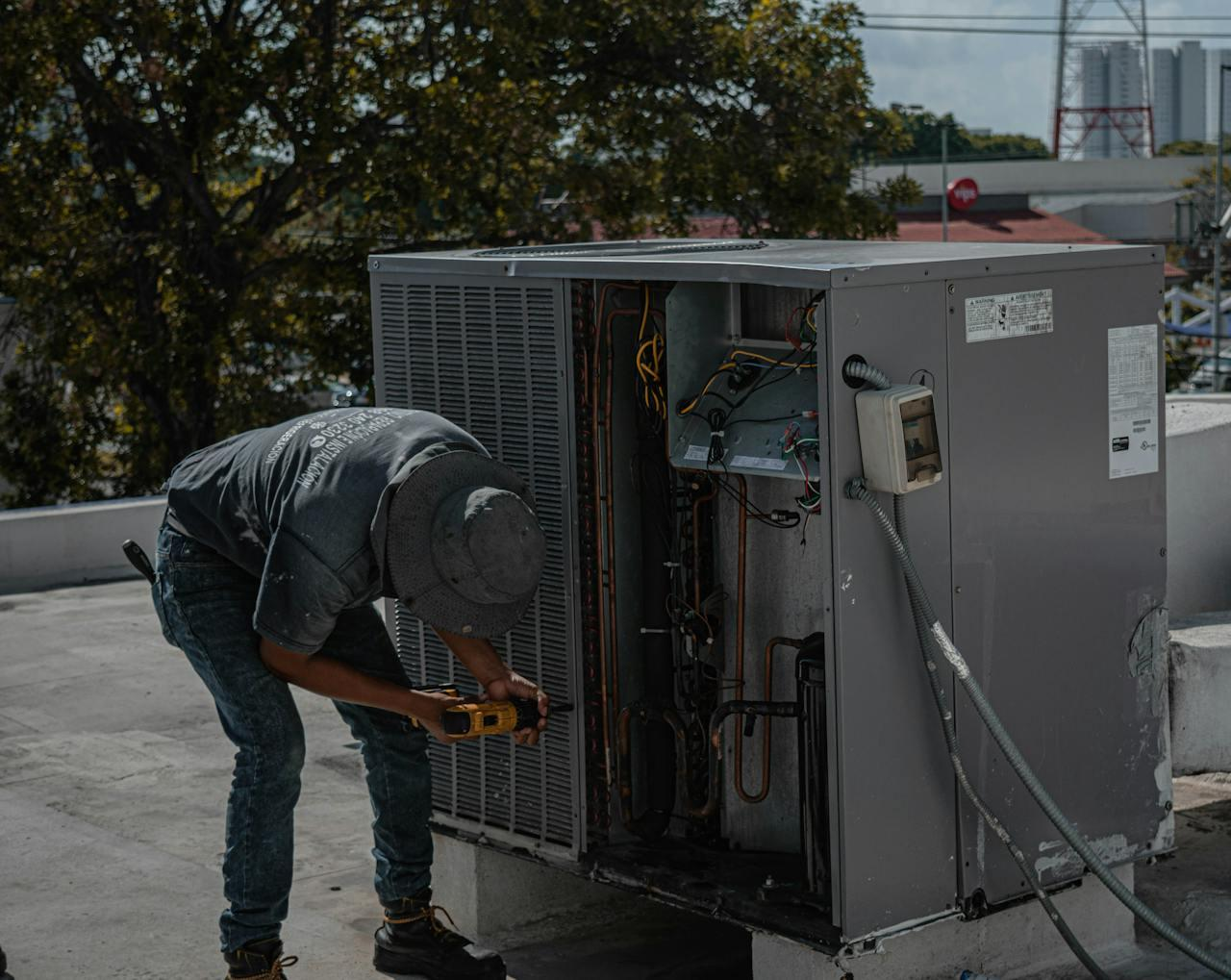 https://www.pexels.com/photo/man-drilling-an-aircon-casing-5463581/