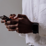 https://www.pexels.com/photo/person-in-white-dress-shirt-holding-black-smartphone-5083010/